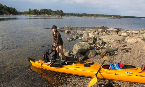 Unpacking kayak on rocky island outside Helsinki Finland